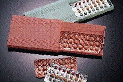Prior to picking, blister packs travel through a long infeed section (above) and transfer to a white-ribbed flighted indexing be