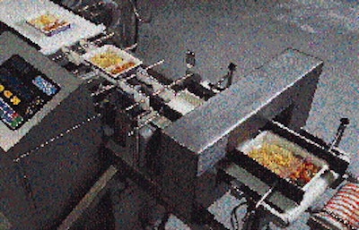 Filled trays pass through metal detection (lower right) and then a checkweigher (upper left