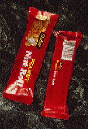 An operator uses a hand-held scanning device to check color consistency (top) on the printed web as it moves through American Pa