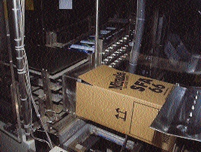 With a case erected and waiting, the packer pushes 12 cartridges into the box before it is transferred back to the line for seal