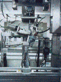 A 70-micron oriented PP sleeve label is applied to the filled and capped PET bottle prior to proceeding through a shrink tunnel