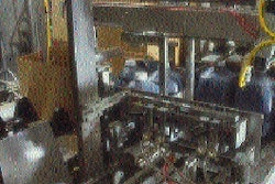 In the packer, four jugs are being pushed onto the case blank before it?s folded and glued