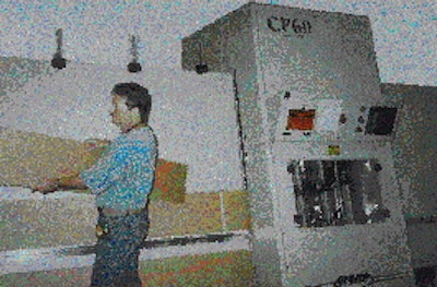 After the CP60 processing machine performs cutting and scoring operations, the sheet of corrugated emerges along a discharge g