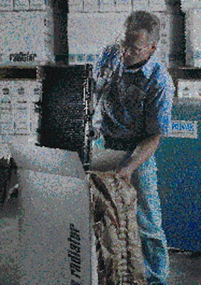 An ARS worker prepares a radiator for shipment. The converter folds kraft paper in a way that creates air pockets, which prov
