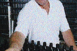 Above: Gary Kulling, plant manager at CPC?s new plant inspects bottles destined to become Coastal Unilube (above, right). At CPC