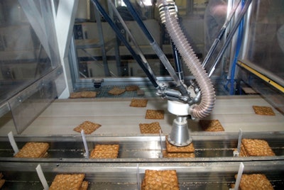 SOFT SUCTION. At crisp maker Wasabr?d, the robotic arm's vacuum pad softly suctions fragile crackers and arranges them in stacks