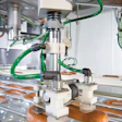 DELICATE TOUCH. Two robots replace eight operators placing sausages into thermoforms with a gentle touch.