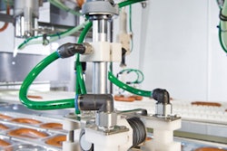 DELICATE TOUCH. Two robots replace eight operators placing sausages into thermoforms with a gentle touch.