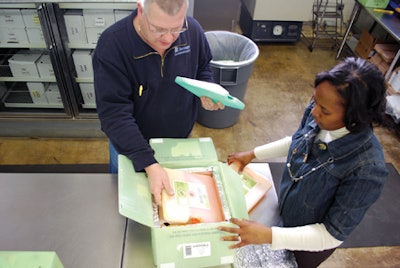 Packaging vaccines. Dr. Suzet McKinney talks with CDPH staff about handling of the H1N1 vaccine as the staff packs Greenbox cont