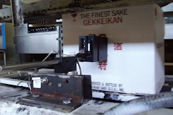 RELIABLE CODES. The new ink-jet printer on Gekkeikan's glass bottle line ensures that cases are codes reliably and clearly every