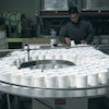 CREATING ORDER. One project, for a powdered household cleanser, begins on APCO Packaging's U-shaped packaging line with manual d