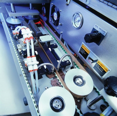 band sealer. Pictured is the interior of the B-500 continuous hand sealer with its heating and cooling bars and Teflon bands.