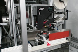 TRAY LABELING. Freshly erected paperboard trays move through this thermal-transfer labeler, which prints variable information su