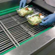 HANDY PACKAGING. An operator places prepared salads in rPET containers two-up at the infeed (above) of the Hera MAP system, also