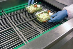 HANDY PACKAGING. An operator places prepared salads in rPET containers two-up at the infeed (above) of the Hera MAP system, also