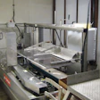 NET SAVINGS. The tandem of case erector (above) and bag inserter (top) have reduced the crew requirements by several people per