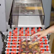 PROTECTIVE PACKAGING. The servo-driven wrapper (above) surrounds each 6-count cannoli shell tray with extrusion-laminated COPP f