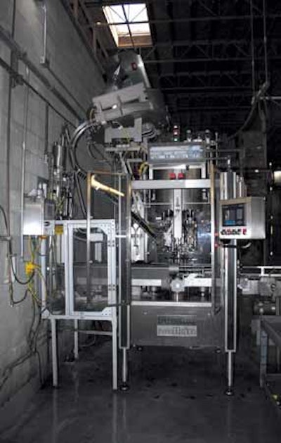 ROTARY CAPPER. This eight-head capper feeds ROPP closures from a hopper onto the bottles and uses a pressure block inside each