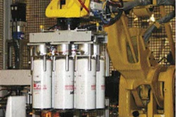 GRIPPING PERFORMER. The four-axis case-packing robot's custom end effector lifts and places industrial filters as a group into t