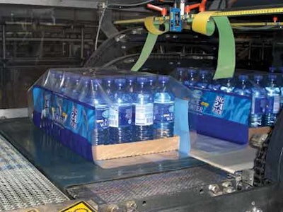 LANE COMBINING. Printed film is applied in register (above) to a 24-count tray of bottles. Three lanes of freshly blown bottles