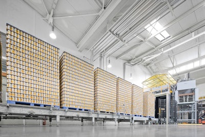 A specially designed pallet conveyor has been designed to handle a high volume of pallets and supply enough cans for a complete production shift.