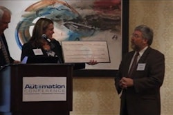 Lloyd Ferguson, Managing Partner, provides a check to Purdue Calumet University.