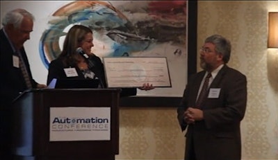 Lloyd Ferguson, Managing Partner, provides a check to Purdue Calumet University.