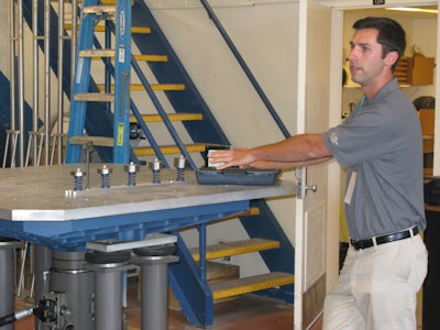 Evan Cernokus, a grad student in Cal Poly's Packaging Program, demonstrates testing equipment in the Cal Poly labs.