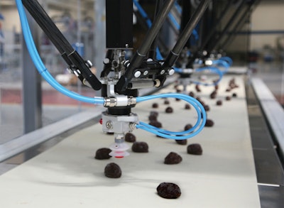 With the use of smart vision software, the four robots at Ozersky Souvenir accurately and gently pick irregularly shaped chocolates and place them on a separate conveyor at a rate of 360/min.