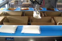 End-of-arm pouch-picking tools use fingers covered in hardened rubber to grab a pouch and lift it into a case.