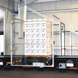 Viewed from the side, the pallet is in the central station of the three-station FireTag system; infeed is to the right and discharge to the left.