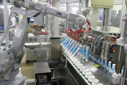 Empty tubes are picked from boxes by the robot’s twin-row end effector and placed in the filler’s pucks.