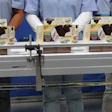 Set-up cartons proceed to the hand-load conveyor for gentle, manual top-loading of baked goods.