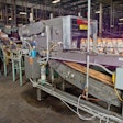 Corrugated trays are fed into a machine that puts two 12-count cartons into each tray.