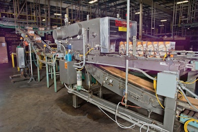 Corrugated trays are fed into a machine that puts two 12-count cartons into each tray.