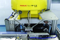 A high-speed delta robot uses a vacuum end-of-arm tool to pick up individual diagnostic test kits and feed them to a flow wrapper.