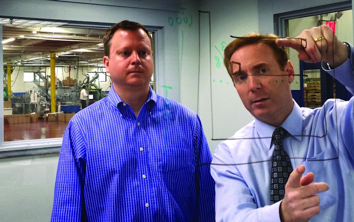 CSS President & CEO Elisha Tropper (right) and company VP of Sales & Marketing Brian Lyle analyze the different packaging configuration options yielded by alternative security-seal product designs.