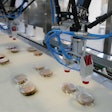 Robotic end effectors are guided to the precise position of the incoming flow-wrapped patties by a vision system.