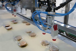 Robotic end effectors are guided to the precise position of the incoming flow-wrapped patties by a vision system.