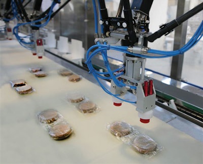 Robotic end effectors are guided to the precise position of the incoming flow-wrapped patties by a vision system.