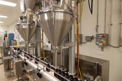 Bottles on the conveyor line pass underneath the two Spee-Dee fillers. After the bottles are filled they are sealed and prepped for shipping.