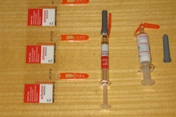 Schreiner-Medipharm's Needle-Trap. It’s a pressure-sensitive label solution for syringes that addresses the problem of sharps. Included here is a photo of (from left to right) three labels still on their release liner, a freshly labeled syringe with its protective needle sheath in place, and a post-injection syringe with its needle safely trapped in plastic with no opportunity whatsoever for harm to healthcare personnel. All that’s left is disposal into the nearest sharps container. According to Schreiner M