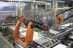 MULTIPLE ROBOTS. Photo shows how robots one, two, and three automatically move lidded plates to the retort crates.