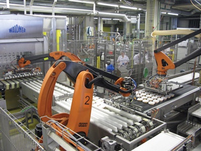 MULTIPLE ROBOTS. Photo shows how robots one, two, and three automatically move lidded plates to the retort crates.