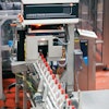 QUALITY INSPECTION. An inspection system immediately following the monobloc rinser/filler/capper on Line 9 (left) inspects the package fill level and cap placement. The same system is also used on Lines 8 and 10.