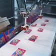 FAST PACKING. Three vision-guided high-speed Delta robots at Swizzels pick-and-place bags of Squashies candy into display cases at speeds to 360/min.