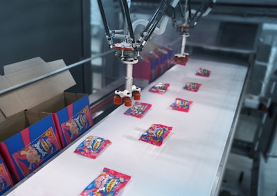 FAST PACKING. Three vision-guided high-speed Delta robots at Swizzels pick-and-place bags of Squashies candy into display cases at speeds to 360/min.