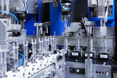 U.S. pharmaceutical firm orders auto injector production. Shown here is the fully automated insertion of a spring into a plastic auto injector component.