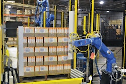 ROBOTIC APPLICATION. Protective corrugated cornerboards are applied automatically by this robotic system just before stretch wrap is applied to the pallet.