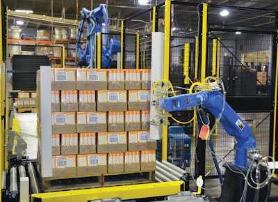 ROBOTIC APPLICATION. Protective corrugated cornerboards are applied automatically by this robotic system just before stretch wrap is applied to the pallet.
